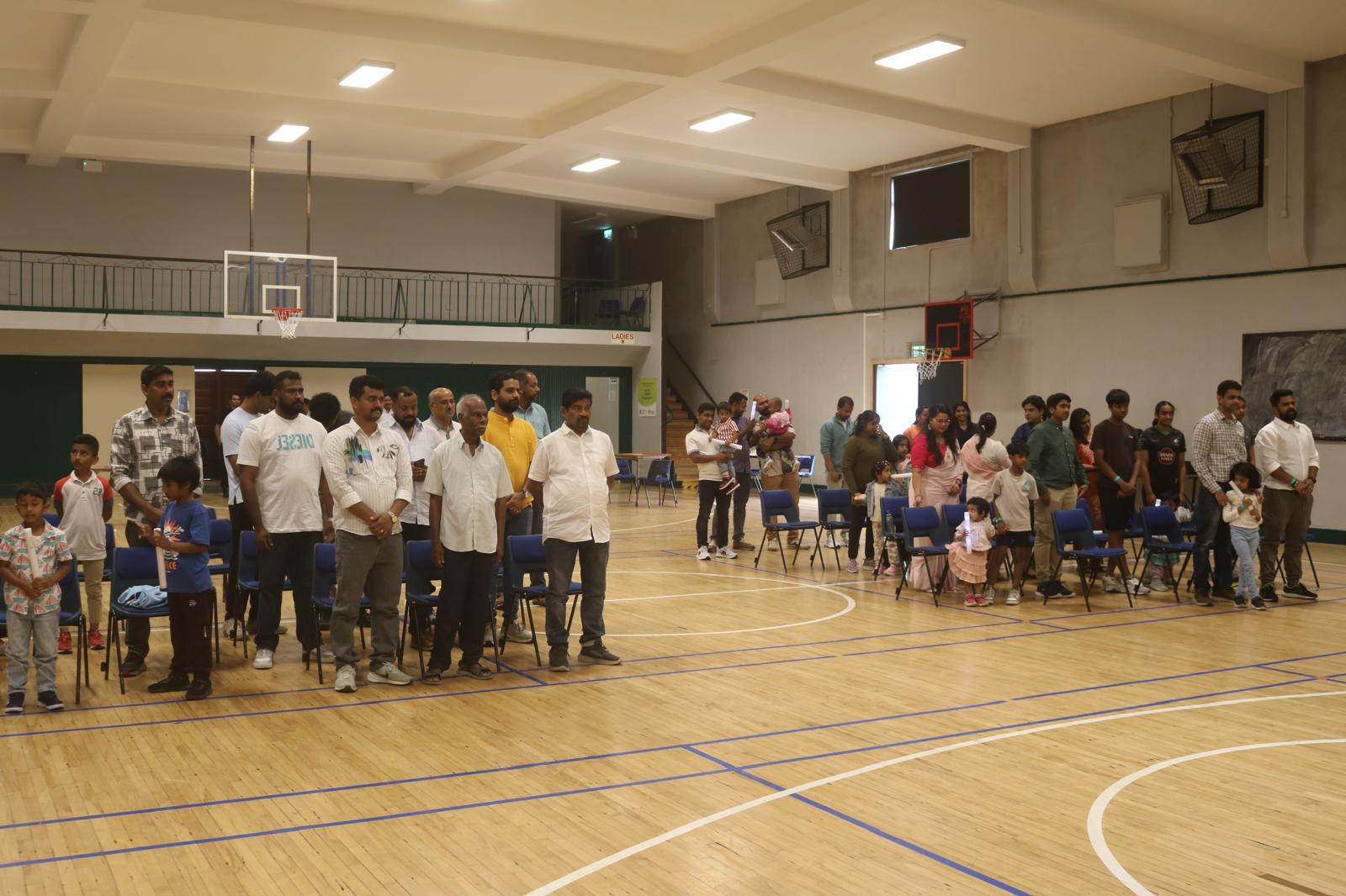 Community members standing together during the anthem